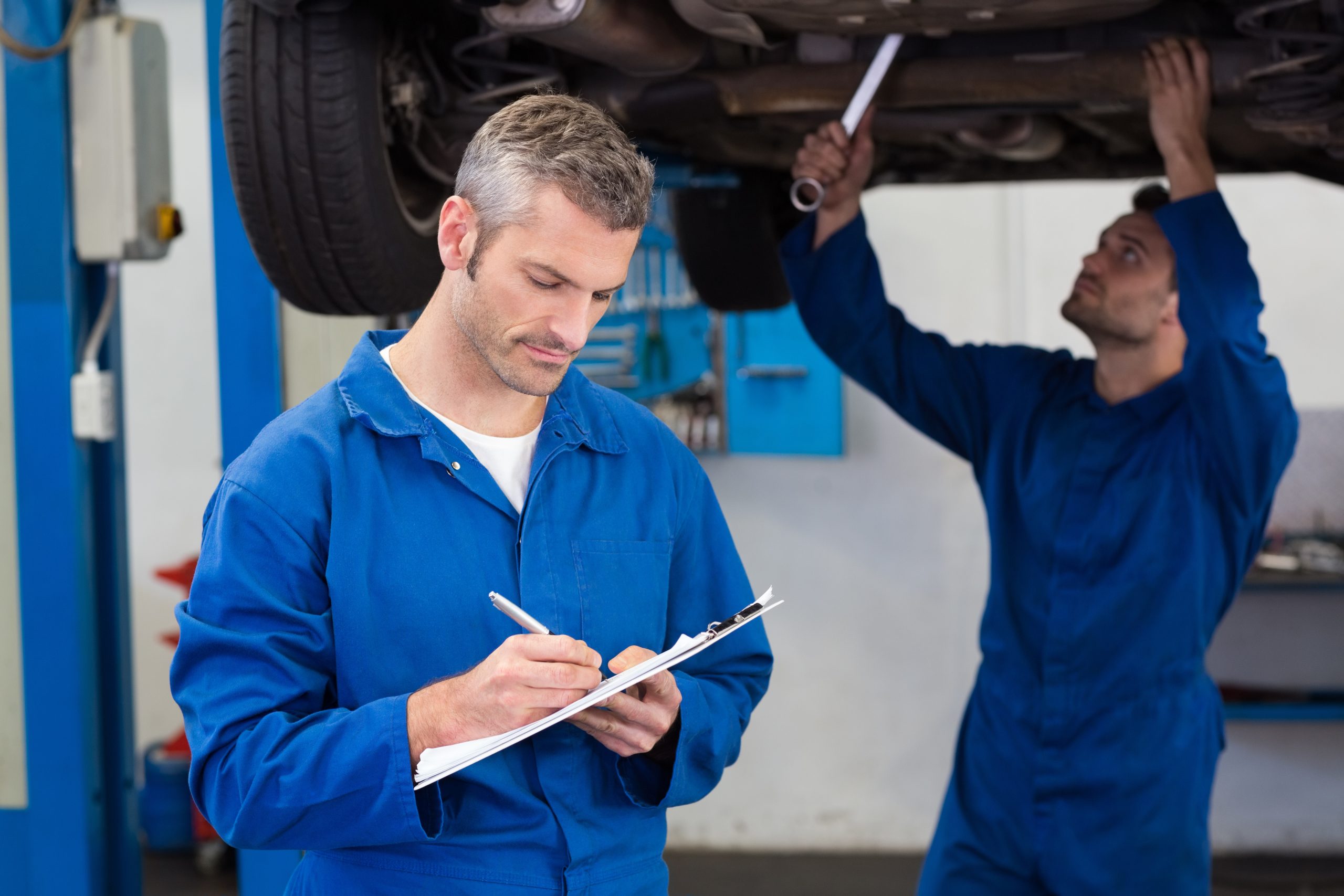 Team of mechanics working together at the repair garage
