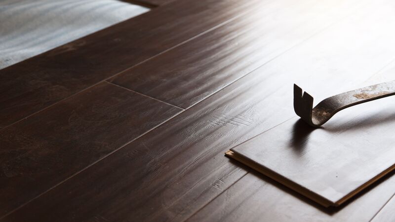14203155 – pry bar tool with new laminate flooring abstract.